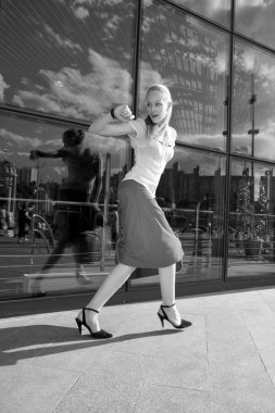 Black and White Young woman, blond, runs against the backdrop of clipart