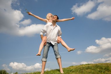 Happy Young love Couple - jumping under blue sky clipart