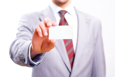 A studio shot of a businessman holding out a blank business card clipart