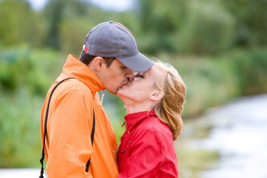 Young love Couple kissed on coast of river clipart