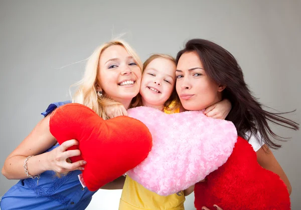 Two beautiful girls and a little girl with hearts — Stock Photo, Image