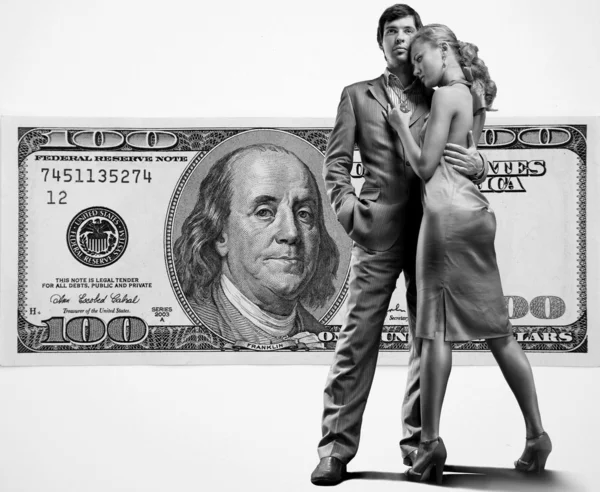Young beautiful couple under money — Stock Photo, Image