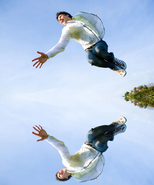 Happy young man - jumping end flies in blue sky. — Stock Photo, Image