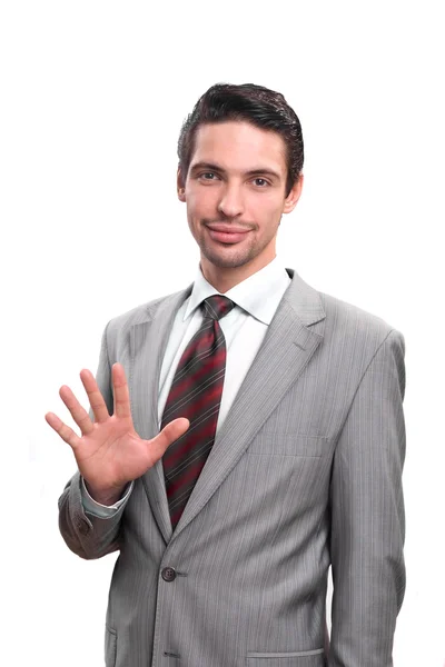Empresário em um terno mostra uma palma em um fundo branco — Fotografia de Stock