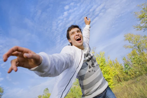 Happy young man - flies in blue sky. — Stock Photo, Image