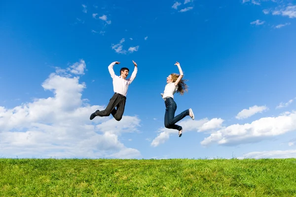 Happy Young Couple Team Jumping Sky Green Meadow — 스톡 사진