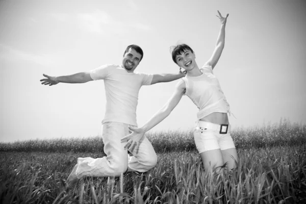 Happy Young Couple Team Jumping Sky Green Meadow — Stock Fotó