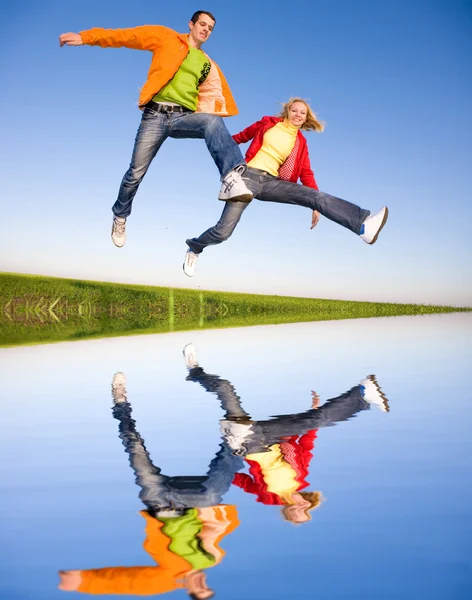 Lyckligt Leende Par Hoppa Blå Himmel — Stockfoto