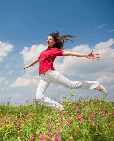 Happy young woman jumping Stock Picture