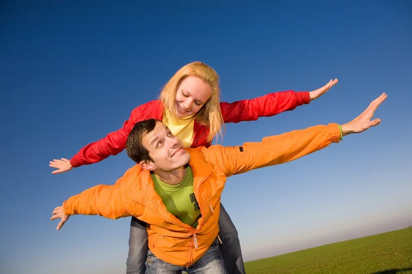 Happy smiling couple fly in sky Stock Image