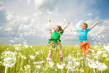 Two golden-haired children playin the field clipart