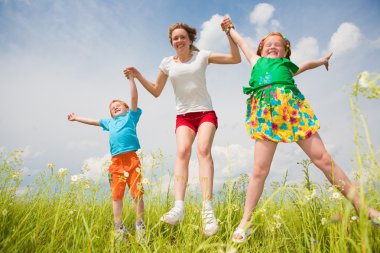 Mother with children Having Fun in the field clipart