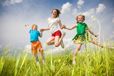 Mother with children Having Fun in the field. Foces on eyes. clipart