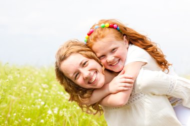 Mom and Daughter Having Fun in the field. Foces on eyes. clipart