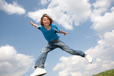 Happy jumping boy. Soft focus. Focus on eyes clipart