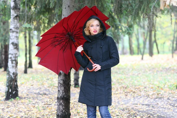 Beautiful blonde outdoors in coat and hat — Stock Photo, Image