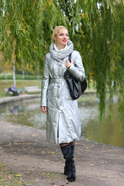 Beautiful blonde outdoors in coat and hat — Stock Photo, Image