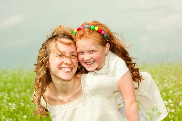 Mother and daughter with flower. Focus on eyes — Stock Photo, Image