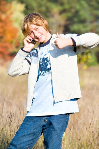 Boy talks on phone end showing everything is OK — Stock Photo, Image