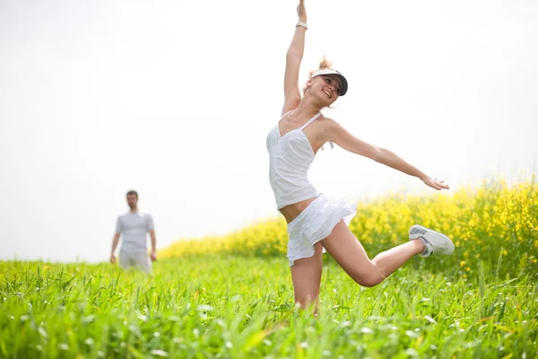 Happy is jumping in field — Stock Photo, Image