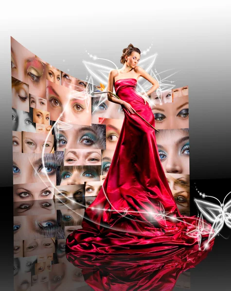 Menina bonita em vestido vermelho contra fantasia borboleta luminosa — Fotografia de Stock