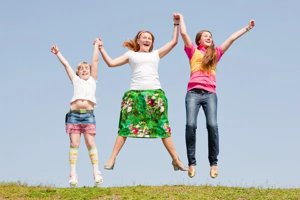 Happy Mother Two Daughter Jumping Green Meadow — Stock Photo, Image