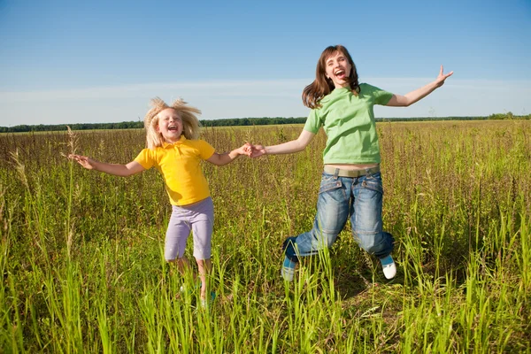 Lycklig mor och dotter på fältet — Stockfoto