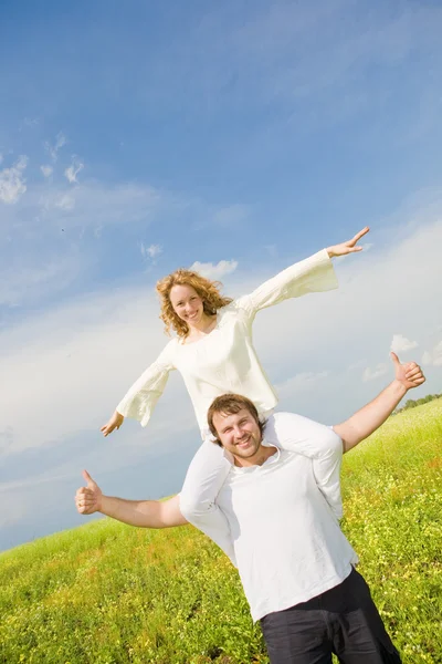 Young love Couple smiling under blue sky Stock Picture