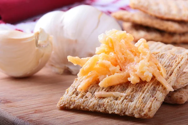 Wheat crackers with grated cheese. — Stock Photo, Image