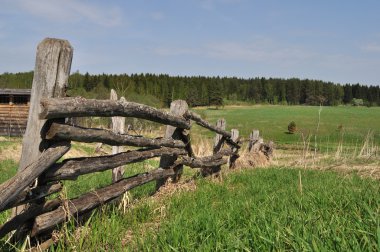 Old pole fence on outskirts clipart