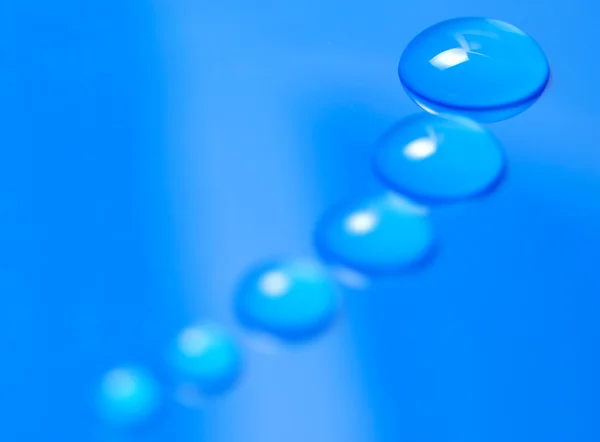 Macro disparo de gotas de agua azul —  Fotos de Stock