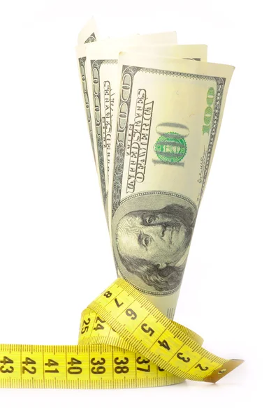 Доллары с желтым метром — стоковое фото