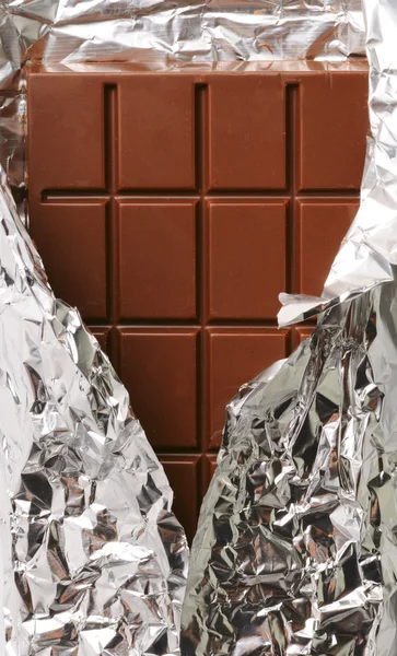 Closeup of chocolate with foil wrapping — Stock Photo, Image