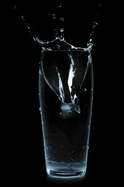 Splash in water glass isolated on black — стоковое фото
