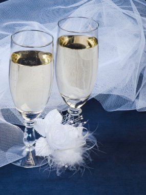 Glasses with champagne and weddings buttonholes clipart