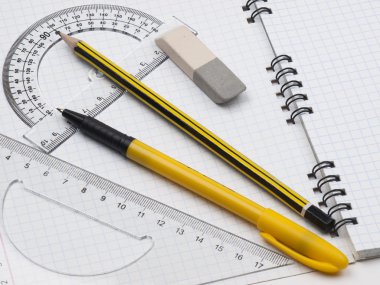 Rulers with pencil on the workbook page clipart