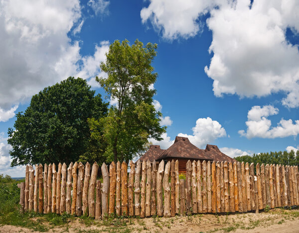 Rural houses fenced with a wooden paling