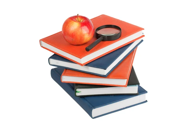 Ripe apple and magnifying glass on books — Stock Photo, Image
