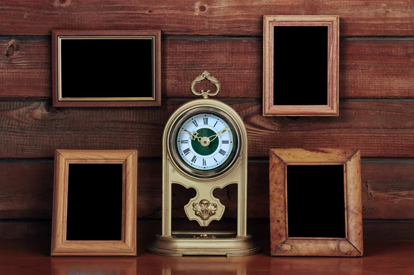 Old photo frames and antique clock — Stock Photo, Image