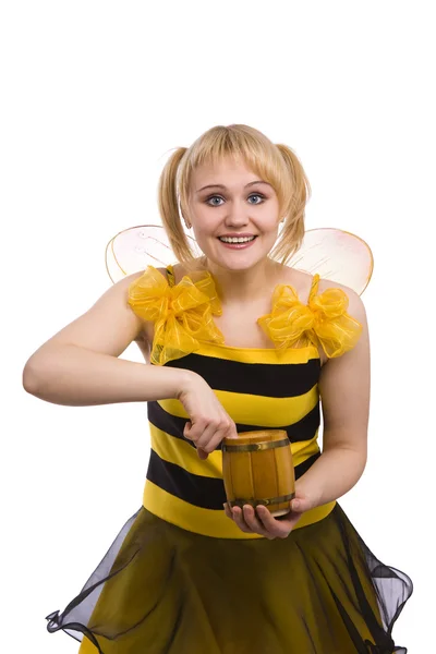 蜂の衣装の女性は蜂蜜を食べています。. — ストック写真