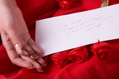 Parting note. Woman hold wedding rings clipart