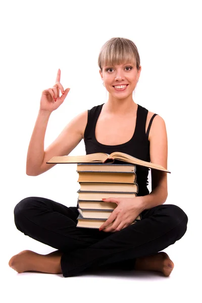 Student sitter med stack av bok — Stockfoto