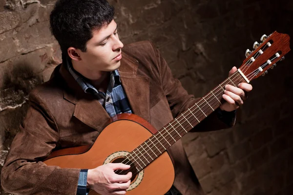 stock image Young man playing on guitar