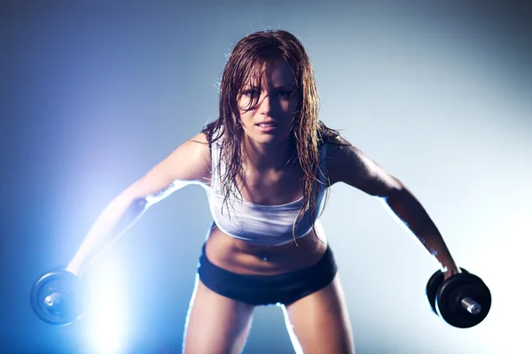 Young strong sexy woman with dumbbells — Stock Photo, Image