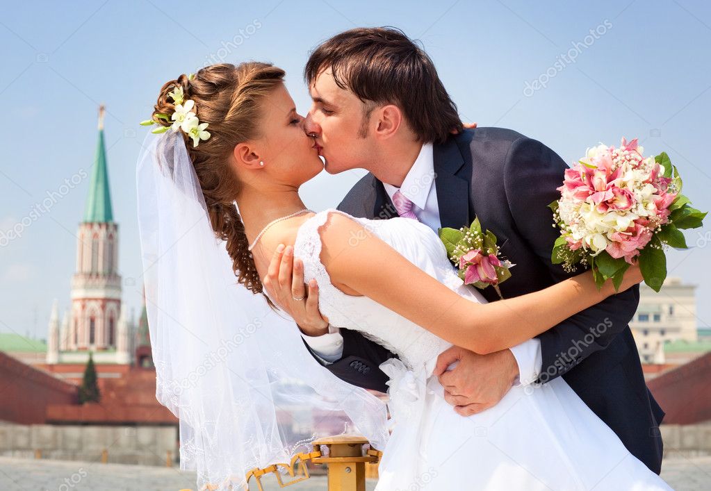 Young wedding couple kissing
