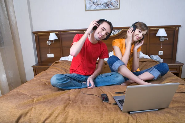 Young couple with musical ear-phones Stock Picture