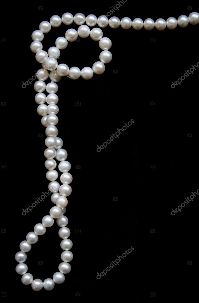 White pearls on the black velvet background, Stock image