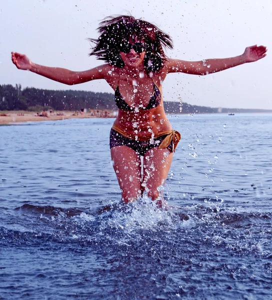 Girl splashing in Baltic sea water — Stock Photo, Image