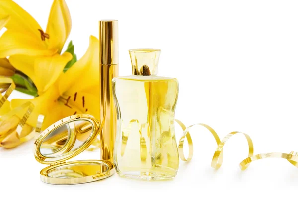 Perfume bottle and makeups in gold — Stock Photo, Image