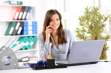 Young business woman holding the phone clipart